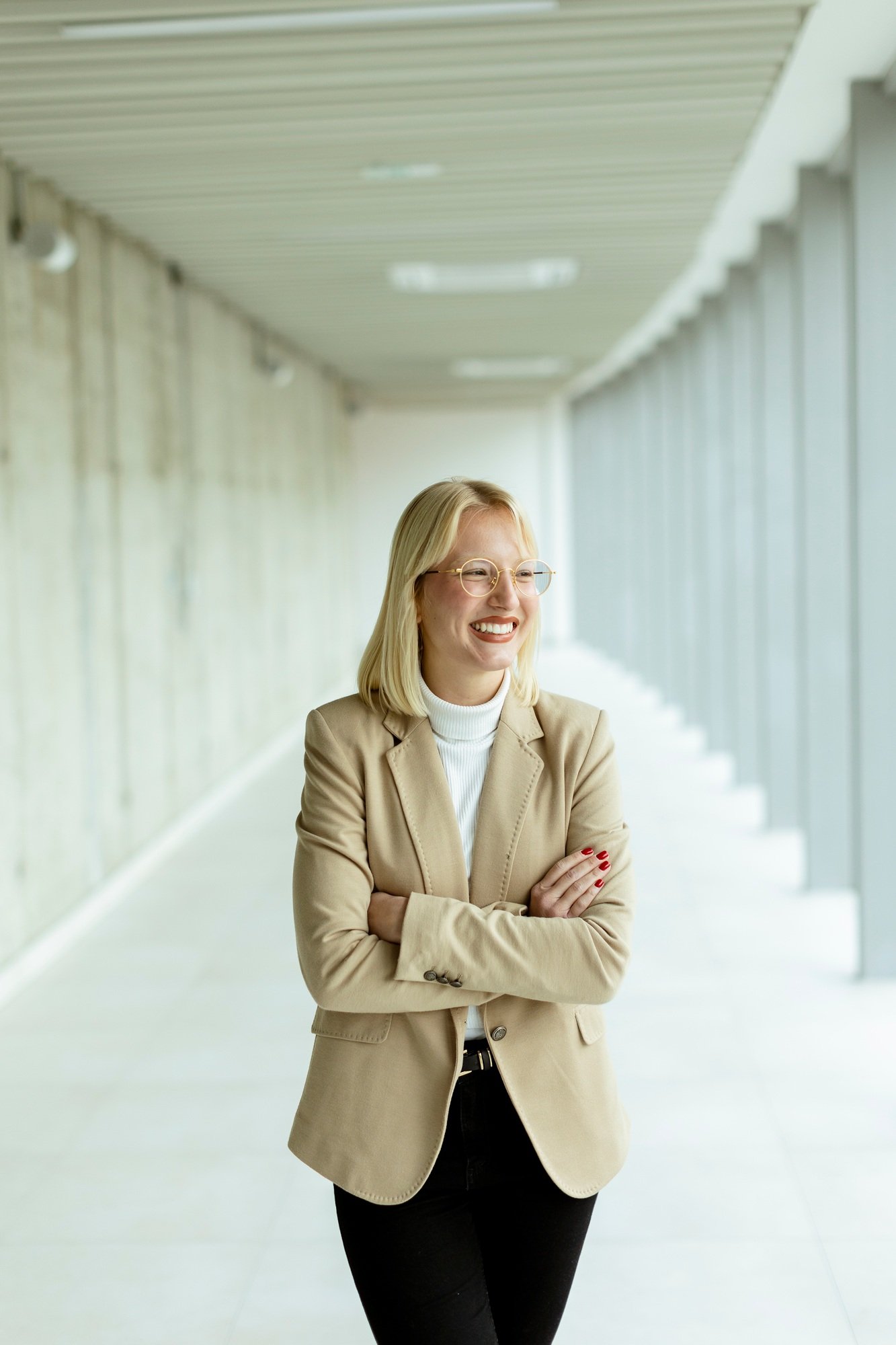 Business woman standing in the office corridor